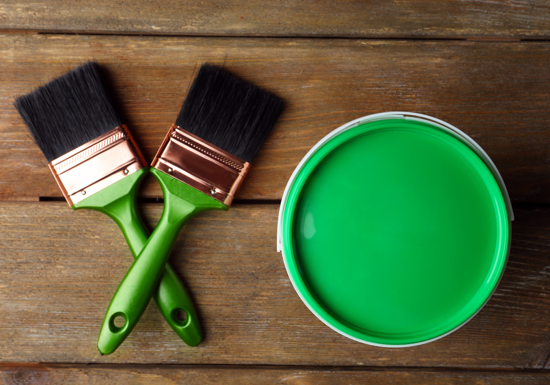 Green paint and paint brushes