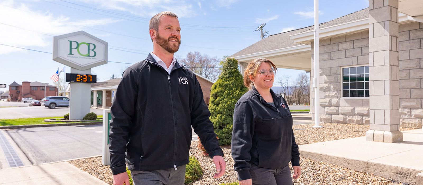 Two people walking outside