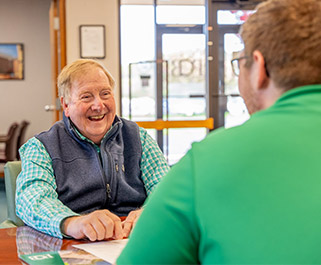 man smiling and having a conversation