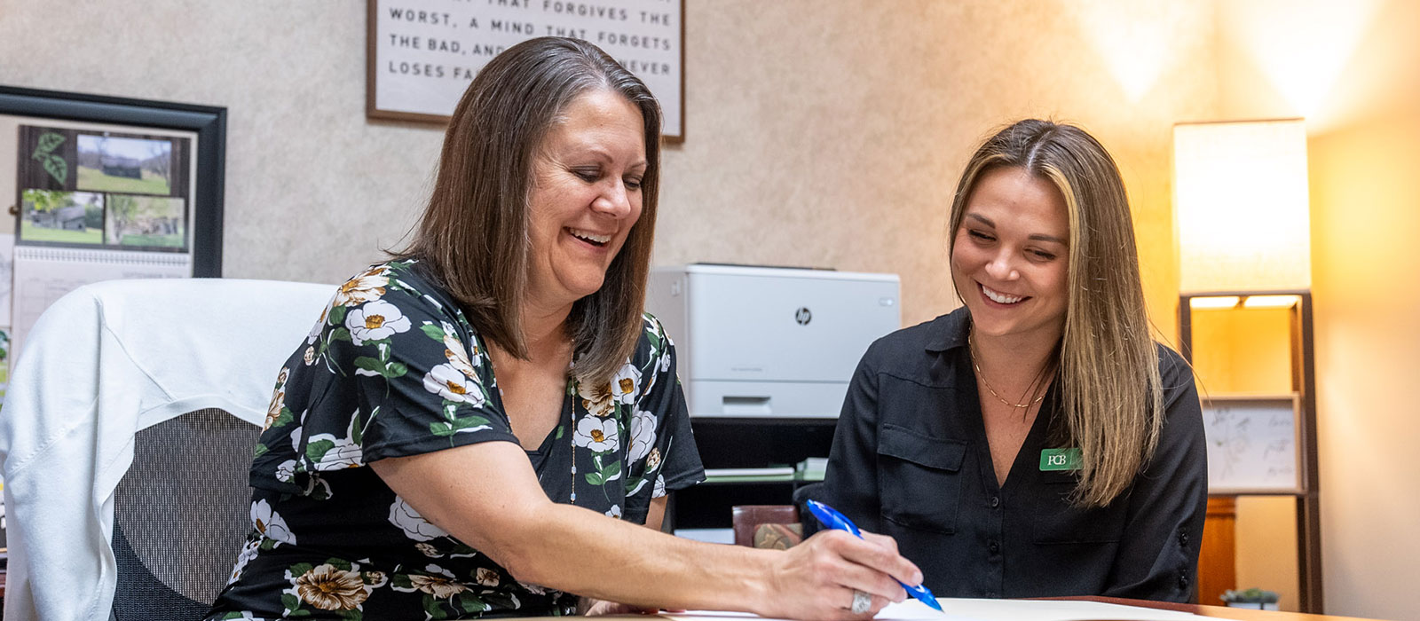 Two people sitting at a desk