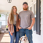 Couple and dog on front porch
