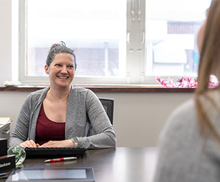 Woman smiling and talking with a customer