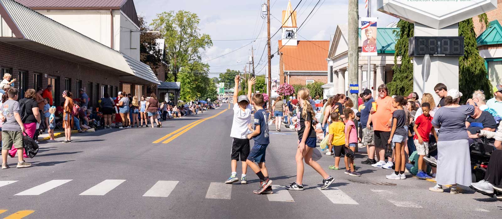 lots of people around a street for a parade