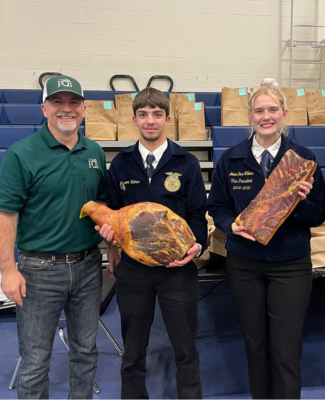 three people at a livestock sale