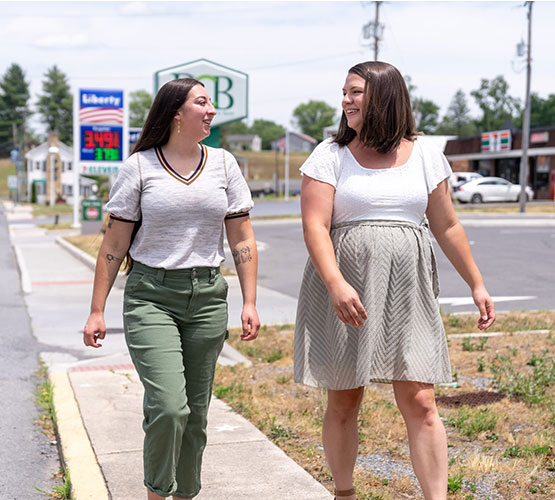 Two people walking down the street