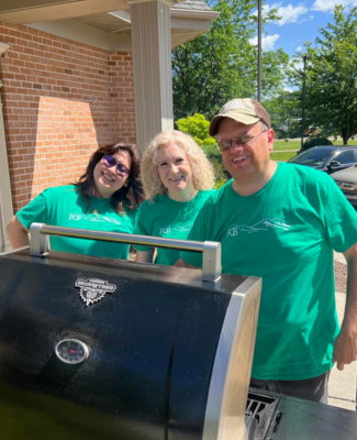 people grilling hot dogs