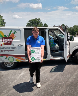 a person volunteering by carrying boxes