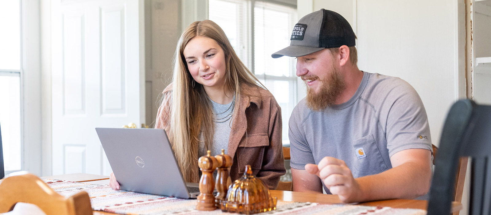 Man and woman looking at a laptop