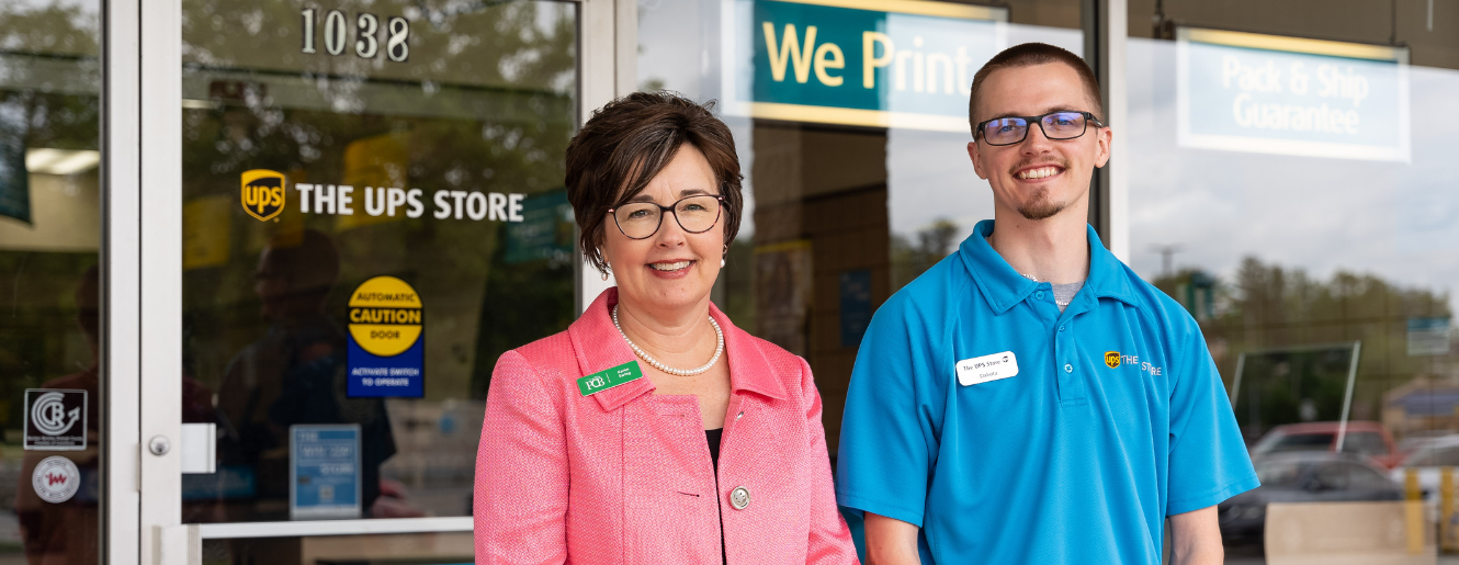 Man and women in front of the UPS Store