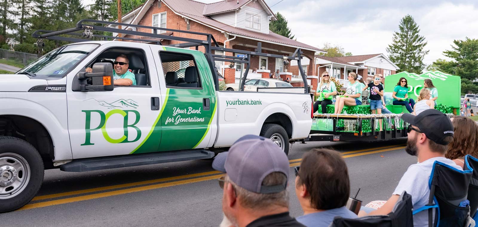 PCB Truck with float and employees in a parade