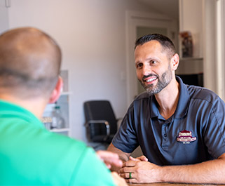 man smiling and having a conversation