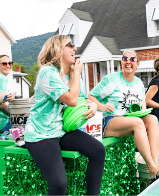 people laughing in a parade route