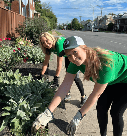 two people volunteering by pulling weeds