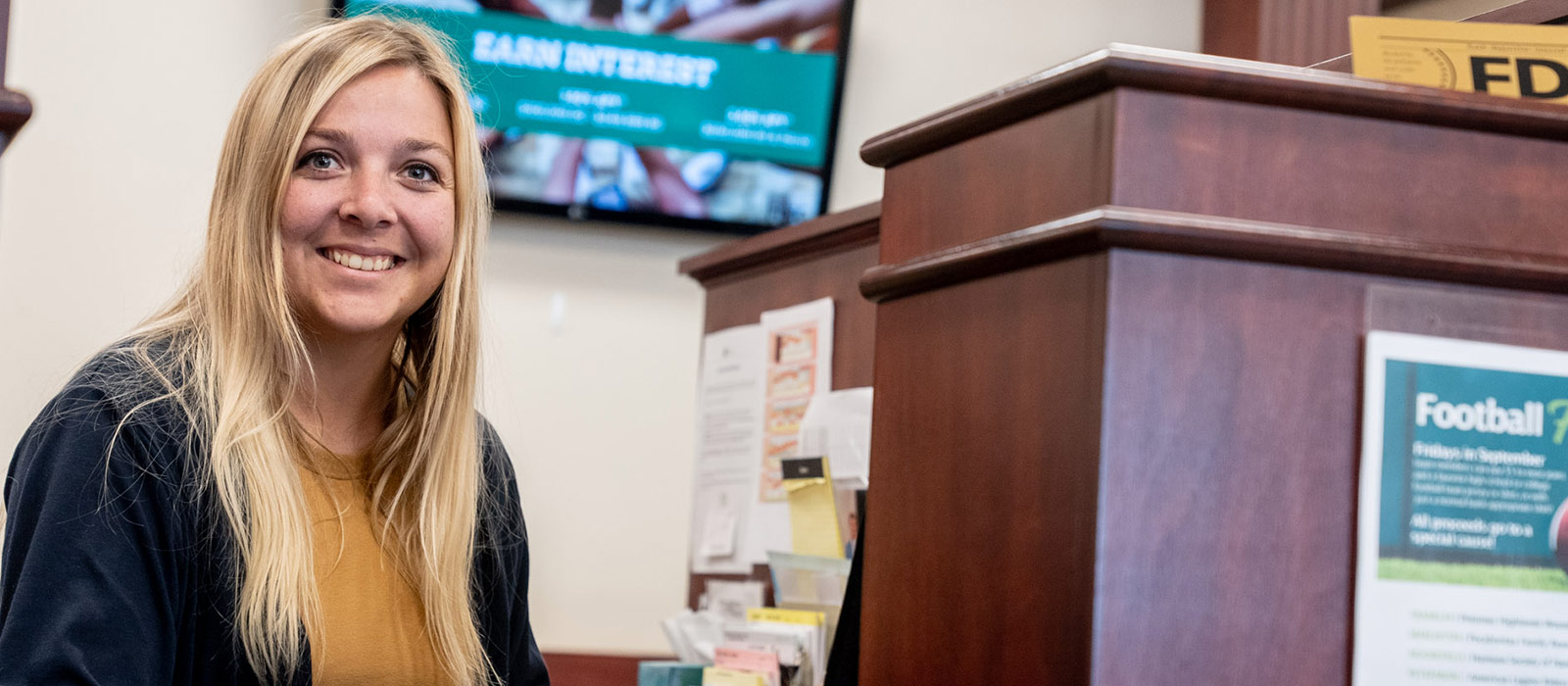 Woman smiling behind teller line