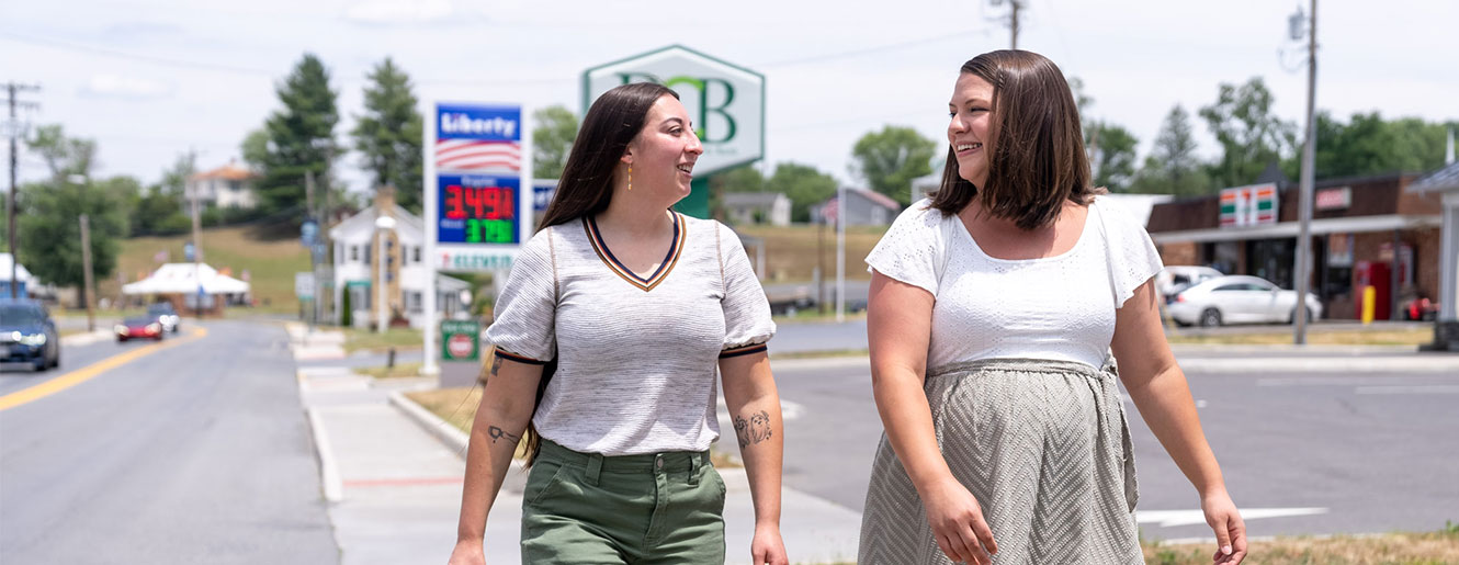 Two people walking down main street