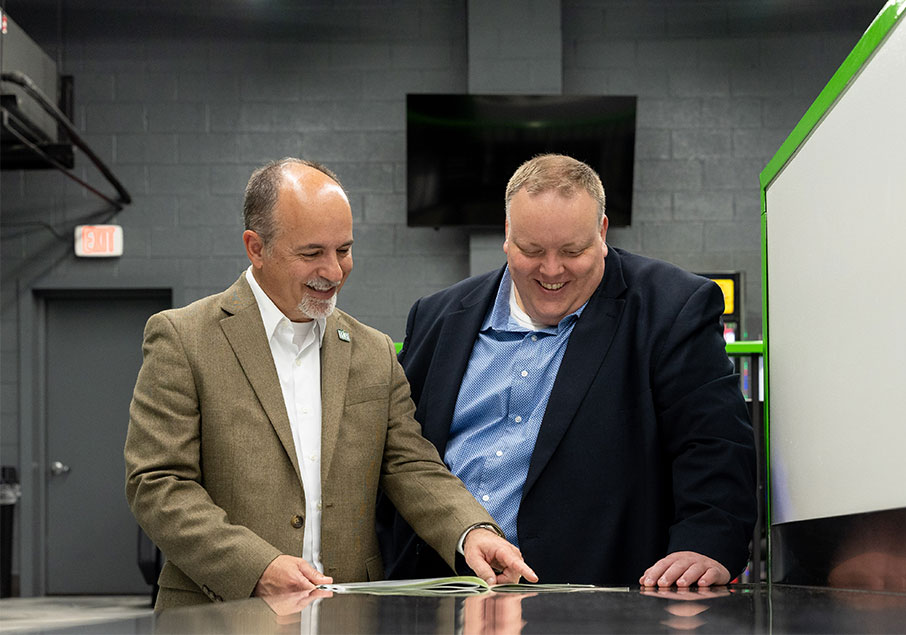 Two people looking at a booklet