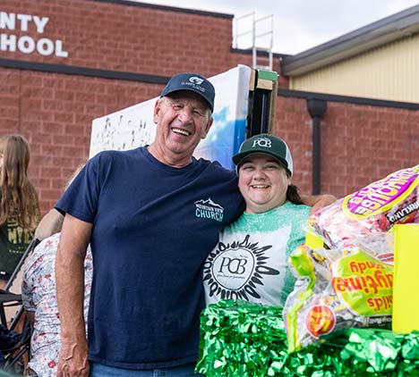 PCB employee and community member smiling and looking at the camera