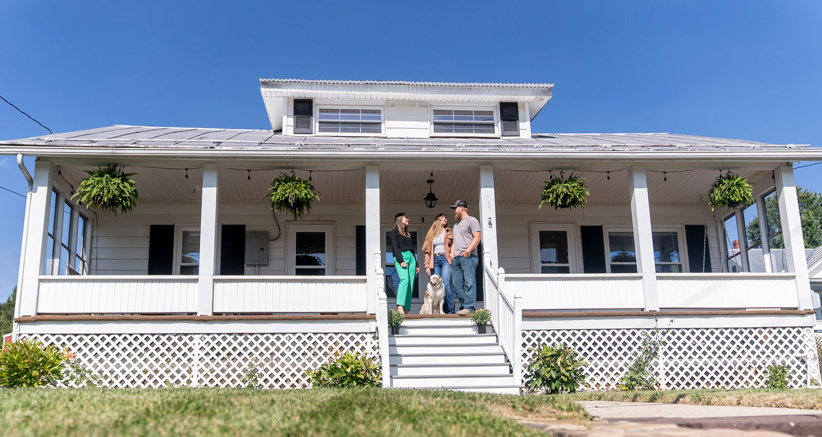 Group of people standing on front porch of home