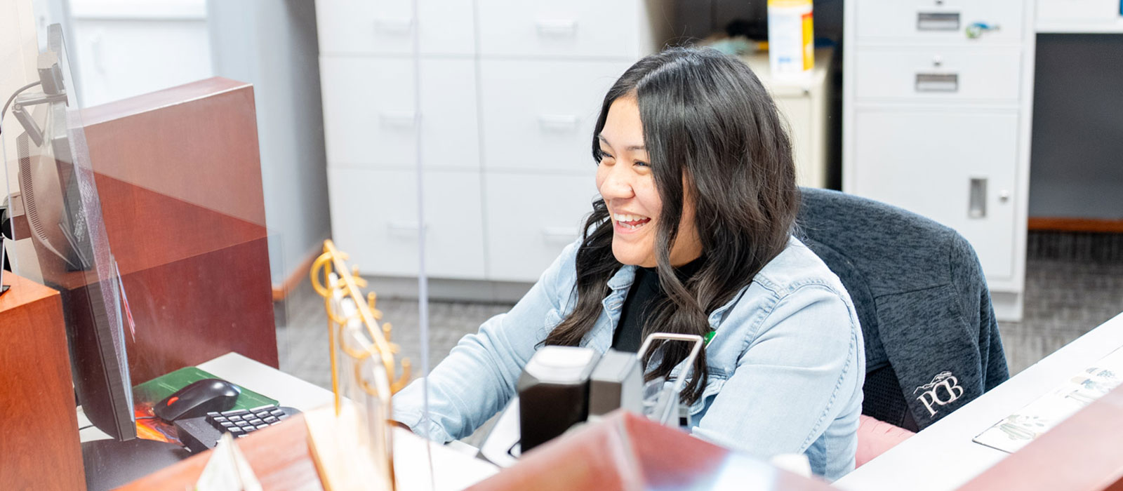 Woman working behind a teller line