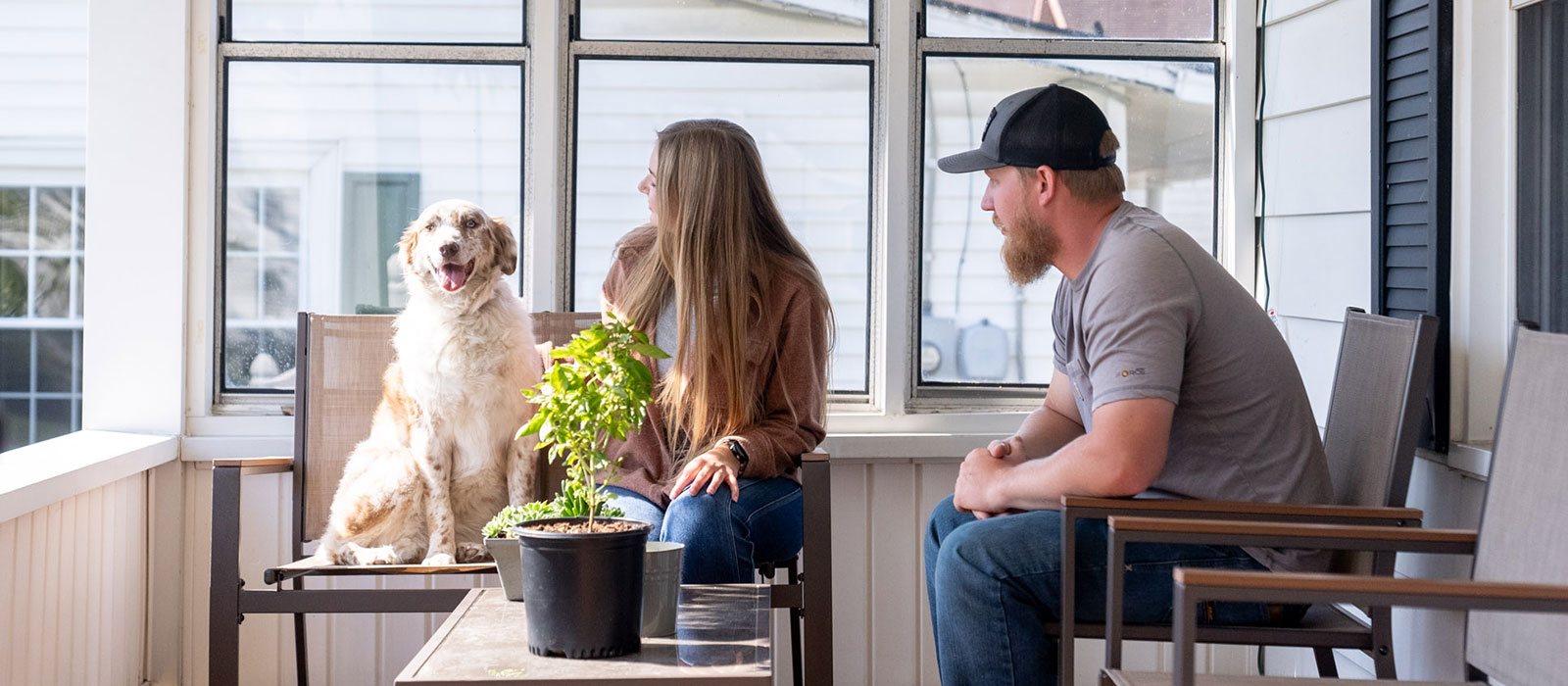 People sitting on porch with their dog