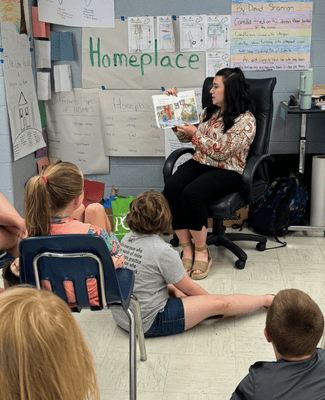 a person reading to students