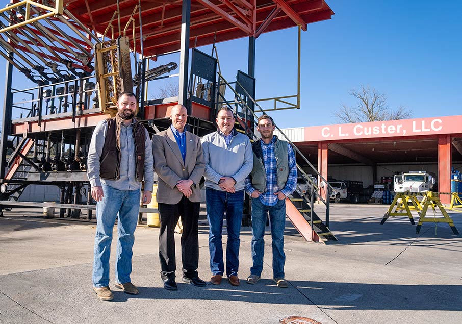 Four people outside a business